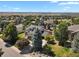 Aerial view of a home nestled among trees in a neighborhood with mountain views at 5421 Potentilla Ct, Parker, CO 80134