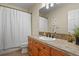 Bathroom with a light wood vanity, tiled countertop, and a shower/tub with patterned curtain at 5421 Potentilla Ct, Parker, CO 80134