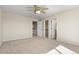 Bedroom with neutral walls, carpet floors, closet, ceiling fan, and attached bathroom at 5421 Potentilla Ct, Parker, CO 80134