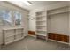 Walk-in closet with custom shelving, window and ample storage space at 5421 Potentilla Ct, Parker, CO 80134