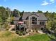 Beautiful home with a stone base, large windows, and a spacious deck with a red umbrella at 5421 Potentilla Ct, Parker, CO 80134