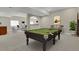 Basement game room with billiard table, bar seating, and a comfortable sitting area at 5421 Potentilla Ct, Parker, CO 80134