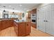 Kitchen featuring wooden cabinets, stainless steel appliances, a center island cooktop, and modern lighting at 5421 Potentilla Ct, Parker, CO 80134