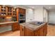 Kitchen featuring wooden cabinets, stainless steel appliances, a built-in desk, and granite countertops at 5421 Potentilla Ct, Parker, CO 80134