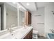 Bright bathroom with a double vanity, ample mirror space, neutral wall, and tiled shower at 8727 E Girard Ave, Denver, CO 80231
