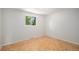 Comfortable bedroom with wood parquet flooring, a large window, neutral decor, and natural light at 8727 E Girard Ave, Denver, CO 80231