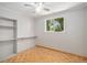 Cozy bedroom with wood parquet floors, built-in shelving, a window with treetop views, and neutral paint at 8727 E Girard Ave, Denver, CO 80231