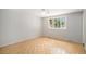 Spacious bedroom with parquet floors, a large window, neutral paint, and abundant natural light at 8727 E Girard Ave, Denver, CO 80231