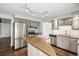 Functional kitchen with stainless steel appliances, wood floors, a central island, and ample counter space at 8727 E Girard Ave, Denver, CO 80231