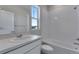 Bright bathroom with a shower over tub, single sink vanity, and neutral tile creating a fresh, modern space at 13398 E 99Th Pl, Commerce City, CO 80022