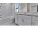 Modern bathroom featuring tile floors, shower over tub, and a vanity with ample storage in a well-lit space at 13398 E 99Th Pl, Commerce City, CO 80022