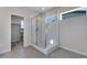 Ensuite bathroom with glass door shower and grey tiled floor at 13398 E 99Th Pl, Commerce City, CO 80022