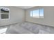Well-lit bedroom with plush carpet, large windows offering great natural light, and scenic outdoor views at 13398 E 99Th Pl, Commerce City, CO 80022
