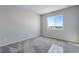 Well-lit bedroom with plush carpet, large windows offering great natural light, and scenic outdoor views at 13398 E 99Th Pl, Commerce City, CO 80022