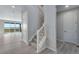 Bright entryway featuring a staircase with carpeted steps and a view into the living space at 13398 E 99Th Pl, Commerce City, CO 80022