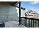 Front porch with dark wood rails looking out to the yard at 13398 E 99Th Pl, Commerce City, CO 80022