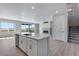 Open kitchen and living area with island seating, fireplace and sliding doors to outside at 13398 E 99Th Pl, Commerce City, CO 80022