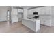 Modern kitchen with white cabinets, stainless steel appliances, and a large center island at 13398 E 99Th Pl, Commerce City, CO 80022