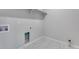 Efficient laundry room with utility connections, tile floor, shelf, and neutral color scheme, ready for appliances at 13398 E 99Th Pl, Commerce City, CO 80022