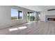 Spacious living room featuring modern fireplace, sliding glass doors, and scenic views at 13398 E 99Th Pl, Commerce City, CO 80022