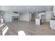 Spacious living room with wood flooring, a fireplace, and an open layout connected to the kitchen at 13398 E 99Th Pl, Commerce City, CO 80022