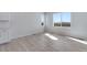 Bright living space features light wood floors, ample natural light, and neutral wall color at 13398 E 99Th Pl, Commerce City, CO 80022