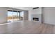 Modern living room featuring a fireplace, large windows, and sliding glass doors to the deck at 13398 E 99Th Pl, Commerce City, CO 80022