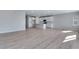 Open floor plan living space with kitchen featuring white cabinets and stainless steel appliances at 13398 E 99Th Pl, Commerce City, CO 80022