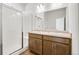 Bathroom with double vanity, a large mirror, and a glass enclosed shower at 9343 Biscay St, Commerce City, CO 80022