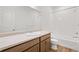 Bathroom with tub/shower combo, single vanity, and hardwood floors at 9343 Biscay St, Commerce City, CO 80022