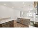Well-designed kitchen with stainless steel appliances, wood cabinets, and a white stone countertop island at 9343 Biscay St, Commerce City, CO 80022