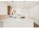 Bright kitchen with white countertops, pendant lighting, stainless steel appliances, and wood cabinets at 9343 Biscay St, Commerce City, CO 80022
