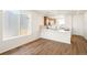 Modern kitchen featuring white countertops, stainless steel appliances, pendant lights, and an adjacent eating area near a window at 9343 Biscay St, Commerce City, CO 80022