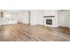 Spacious living room with a fireplace and wood-look flooring at 9343 Biscay St, Commerce City, CO 80022