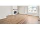 Bright living room with a fireplace and wood-look floors at 9343 Biscay St, Commerce City, CO 80022