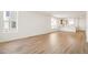 Open-concept living space with wood-look flooring and abundant natural light at 9343 Biscay St, Commerce City, CO 80022