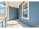 Covered porch featuring a metal railing and modern siding at 9343 Biscay St, Commerce City, CO 80022