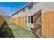 Fenced backyard featuring mature landscaping, patio, and grassy area at 8915 Field St # 118, Broomfield, CO 80021