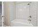 Bathroom featuring tub and shower with white subway tile at 8915 Field St # 118, Broomfield, CO 80021