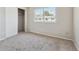Bedroom featuring neutral carpet, window, and closet at 8915 Field St # 118, Broomfield, CO 80021