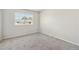 Bright bedroom with neutral carpet and large window at 8915 Field St # 118, Broomfield, CO 80021