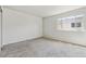 Bedroom boasts neutral walls, gray carpeting, and ample natural light at 8915 Field St # 118, Broomfield, CO 80021