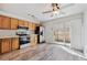 Bright kitchen features stainless steel appliances, wooden cabinets, modern countertops, and outdoor access at 8915 Field St # 118, Broomfield, CO 80021