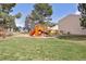 Community playground with swings, slides, and play structure at 8915 Field St # 118, Broomfield, CO 80021