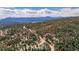 Aerial view of mountain homes nestled among trees with mountain views in the distance at 37 High View Ln, Boulder, CO 80302