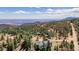 Aerial view of a charming home nestled among trees with beautiful mountain views at 37 High View Ln, Boulder, CO 80302