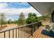Spacious balcony with metal railing and chairs with views of the property's natural landscape at 37 High View Ln, Boulder, CO 80302