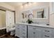 Bright bathroom with double sinks, marble countertops, white cabinets, and a shower-tub combination at 37 High View Ln, Boulder, CO 80302