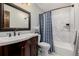 Bathroom featuring a dark vanity, framed mirror, and shower with a blue curtain at 37 High View Ln, Boulder, CO 80302