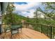 Wooden deck area featuring metal chairs with views of the surrounding forest and natural landscape at 37 High View Ln, Boulder, CO 80302